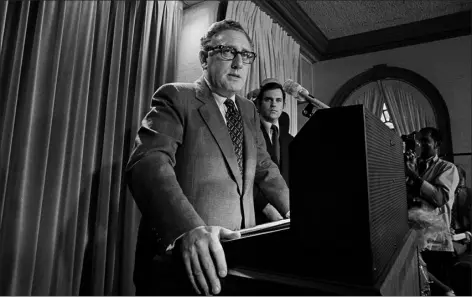  ?? AP PHOTO, FILE ?? In this Oct. 26, 1972file photo, then-presidenti­al adviser Henry Kissinger tells a White House news conference that “peace is at hand” in Vietnam. It turned out Kissinger’s prediction was way off the mark: The heaviest bombing of the war started just before Christmas 1972.