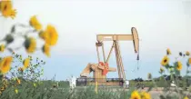  ?? — Reuters ?? A pump jack operates at a well site leased by Devon Energy Production Company near Guthrie, Oklahoma .