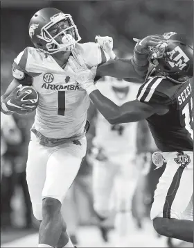  ?? Arkansas Democrat-Gazette/BENJAMIN KRAIN ?? Arkansas wide receiver Jared Cornelius (1) stiff-arms Texas A&M defensive back Alex Sezer Jr. after making a reception during the second half. Cornelius finished with 7 catches for 126 yards and 1 touchdown.