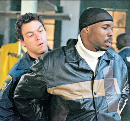  ??  ?? i Art imitating life: McNulty (Dominic West) apprehends drugs kingpin Avon Barksdale (Wood Harris) in The Wire