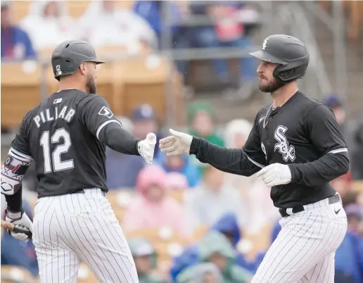  ?? ROSS D. FRANKLIN/AP ?? Shortstop Paul DeJong (right) said a walk to the previous batter, Andrew Vaughn, set the table for his two-run homer against the Cubs on Friday.