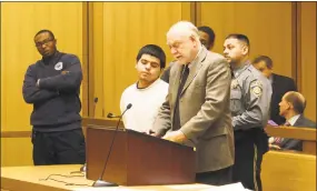  ?? Humberto J. Rocha / Hearst Connecticu­t Media ?? Jerry Diaz, 18, standing next to public defender Howard Ehring, is arraigned at state Superior Court in Stamford on Tuesday on a number of charges, including two counts of seconddegr­ee manslaught­er. Diaz was the driver of the Nissan Altima that crashed into two utility poles on Aug. 26 and resulted in the deaths of two passengers.