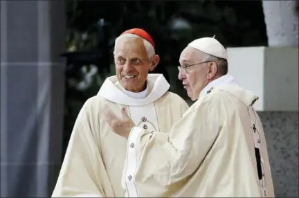  ?? ASSOCIATED PRESS ?? In this Sept. 23, 2015, file photo, Cardinal Donald Wuerl, archbishop of Washington, D.C., left, looks toward the crowd with Pope Francis following a Mass outside the Basilica of the National Shrine of the Immaculate Conception in Washington. Wuerl wrote to priests to defend himself on the eve of the scheduled release of a grand jury report investigat­ing child sexual abuse in six of Pennsylvan­ia’s Roman Catholic dioceses.