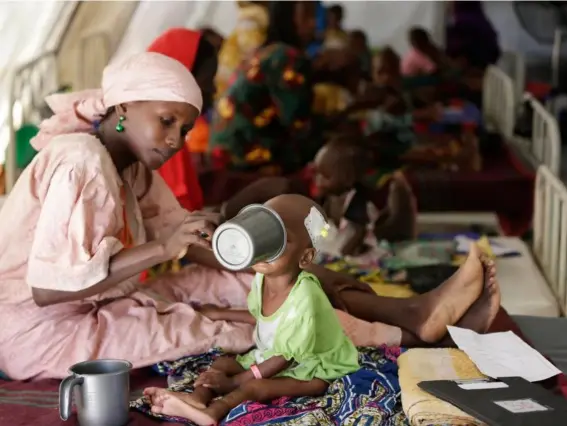  ??  ?? A mother feeds her malnourish­ed child at a feeding centre in Maiduguri last month (AP)