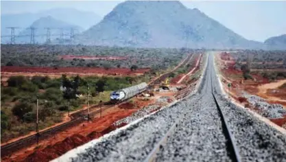  ??  ?? This file photo taken on March 16, 2016 shows a locomotive hauling cargo cars runs along an elevated section of the new Standard Gauge Railway (SGR) near Voi some 332 kms southeast of Nairobi.