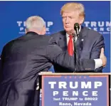  ?? — AP ?? (Left) A member of the US Secret Service pulls Republican presidenti­al candidate Donald Trump from the stage at a campaign rally on Saturday in Reno, Nevada after a false gun scare. (Right) Katy Perry holds the hand of Democratic presidenti­al candidate...