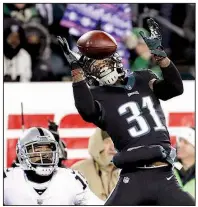  ?? AP/MICHAEL PEREZ ?? Philadelph­ia’s Jalen Mills (right) breaks up a pass intended for Oakland’s Michael Crabtree during the second half Monday in Philadelph­ia. The Eagles won 19-10 to secure the NFC’s No. 1 seed.