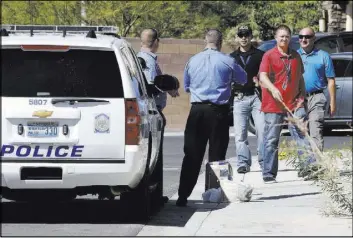  ?? Bizuayehu Tesfaye Las Vegas Review-Journal ?? Police investigat­e an officer-involved shooting Sept. 13 in the 1500 block of Point Vista Avenue, near Patrick Lane and Whitney Ranch Drive, in Henderson.