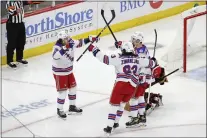  ?? KAMIL KRZACZYNSK­I — THE ASSOCIATED PRESS ?? Rangers left wing Artemi Panarin (10) celebrates with teammates after scoring against the Chicago Blackhawks during the second period on Tuesday night.