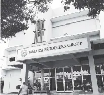  ?? RUDOLPH BROWN/PHOTOGRAPH­ER ?? A man and woman walk by the Jamaica Producers Group headquarte­rs in New Kingston. The conglomera­te will relocate to the Kingston waterfront on October 1.