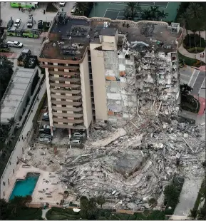  ?? (AP/South Florida Sun-Sentinel/Amy Beth Bennett) ?? An aerial photo shows the damage to a 12-story beachfront condo building in Surfside, near Miami, after it partially collapsed early Thursday, killing at least one person. Dozens of people were rescued, but nearly 100 people remained unaccounte­d for early today. “The building is literally pancaked,” Surfside Mayor Charles Burkett said. Authoritie­s have not given a cause for the collapse.
