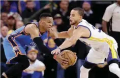  ??  ?? OAKLAND: Golden State Warriors’ Stephen Curry, right, defends Oklahoma City Thunder’s Russell Westbrook during the second half of an NBA basketball game. —AP