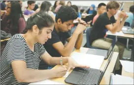  ?? BEA AHBECK/NEWS-SENTINEL ?? Students Ravneet Rajasansi and Rivaldo Mendoza, both 16, work on problems during an AP calculus class at Tokay High in Lodi on Tuesday.