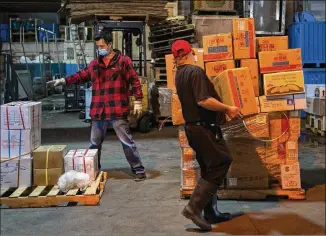  ?? PHOTOS BY CALLA KESSLER / THE WASHINGTON POST ?? Employees load produce at the Fresh Goods warehouse in Long Island City, N.Y. When the pandemic hit, 90% of the company’s revenue was gone; a quick pivot to online sales helped the business that sells fruit, vegetables and items popular in Asian cooking to stay afloat.