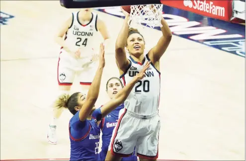  ?? David Butler II / USA TODAY ?? UConn’s Olivia Nelson-Ododa (20) shoots while defended by UMass Lowell’s Denise Solis (25) and Tiahna Sears on Saturday in Storrs.