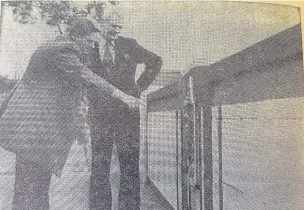  ??  ?? Charles Linford, assistant county engineer and Coun Norman Weall inspect the bridge