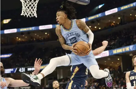  ?? (AP Photo/Brandon Dill) ?? Memphis Grizzlies guard Ja Morant (12) handles the ball under the basket during the second half of the team's NBA basketball game against the New Orleans Pelicans onSaturday, April 9, 2022, in Memphis, Tenn.