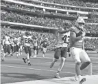  ?? GARY A. VASQUEZ/USA TODAY SPORTS ?? Safety John Johnson, shown trailing Chargers QB Justin Herbert, relayed play calls in a game in which the Browns’ errors cost a couple of TDS.