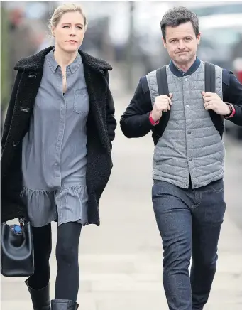  ?? Pictures: ALAN HUCKLE/FLYNET, MAILONLINE/SOLO SYNDICATIO­N ?? Declan Donnelly takes a walk with his wife Ali near their west London home yesterday