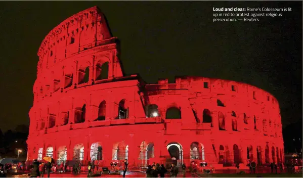  ??  ?? Loud and clear: Rome’s Colosseum is lit up in red to protest against religious persecutio­n.