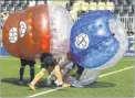  ??  ?? Two teams battle it out during the hilarious Bubble Football Tournament