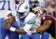  ?? AP PHOTO BY MICHAEL WYKE ?? Kentucky quarterbac­k Terry Wilson (3) is sacked by Texas A&amp;M defensive lineman Kingsley Keke (8) during the second half of an NCAA college football game Saturday, Oct. 6, in College Station, Texas.