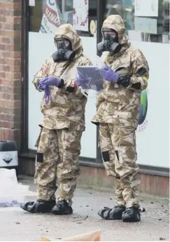  ??  ?? Military teams help clean up the area around where Sergei Skripal and his daughter, Yulia, were found in Salisbury