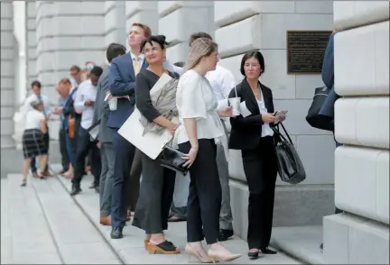  ?? GERALD HERBERT — THE ASSOCIATED PRESS ?? People wait in line to enter the 5th Circuit Court of Appeals to sit in overflow rooms to hear arguments in New Orleans, Tuesday. The appeals court will hear arguments today on whether Congress effectivel­y invalidate­d former President Barack Obama’s entire signature health care law when it zeroed out the tax imposed on those who chose not to buy insurance. A Texas judge in December ruled it was invalid, setting off an appeal by states who support the law.