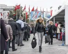  ?? — AFP ?? People queue to buy vegetables at a tent set up by the Istanbul Metropolit­an municipali­ty in the Besiktas district of Istanbul on Tuesday.