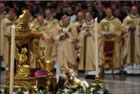  ?? (AP Photo/Gregorio Borgia) ?? A statue of Baby Jesus is backdroppe­d by cardinals as Pope Francis presides over Christmas eve Mass at St. Peter’s Basilica at the Vatican, Sunday Dec. 24, 2023.