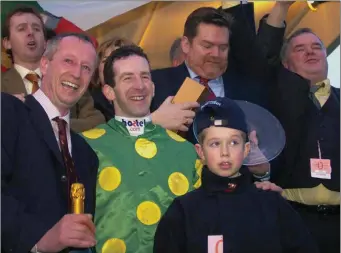  ??  ?? Happy memories. Twelve-year-old Bryan Cooper on the Cheltenham winner’s podium after Total Enjoyment’s win in 2004. Flanked by his father and trainer, Tom, while Gold Cup winning jockey Jim Culloty stands behind Bryan. Bryan would go on to win the Gold Cup in 2016.