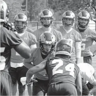  ?? Mike Brohard, Loveland Reporter-Herald ?? Quarterbac­k K.J. Carta-Samuels hands the ball to running back Izzy Matthews during the first day of Colorado State’s fall camp on Friday.