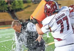  ?? Blanchard head coach Jeff Craig is soaked with water after the Lions defeated Wagoner in the 4A state championsh­ip game Friday at Chad Richison Stadium in Edmond. PHOTOS BY NATHAN J. FISH/THE OKLAHOMAN ??