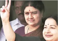  ??  ?? Sasikala seen behind her mentor the late Jayalalith­aa.