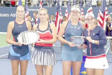  ??  ?? Ashleigh Barty of Australia and Coco Vandeweghe of the United States pose for photos with Timea Babos of Hungary and Kristina Mladenovic of France after the women’s doubles final on Day Fourteen of the 2018 US Open at the USTA Billie Jean King National Tennis Center. — AFP photo