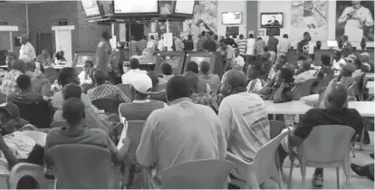  ??  ?? Gamblers wait patiently in a football betting shop in this file picture