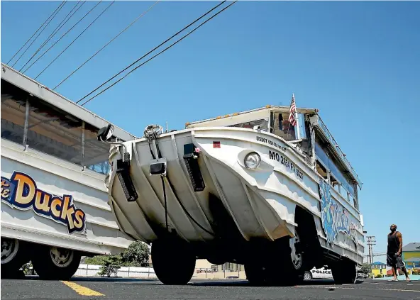  ??  ?? A duck boat sits idle in the parking lot of Ride the Ducks, an amphibious tour operator in Branson, Missouri. The amphibious vehicle is similar to one of the company’s boats that capsized on Table Rock Lake resulting in 17 deaths.