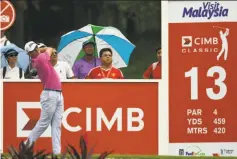  ?? Stanley Chou / Getty Images ?? Justin Thomas swings away during round one of the CIMB Classic in Kuala Lumpur, Malaysia, where he is the defending champion.