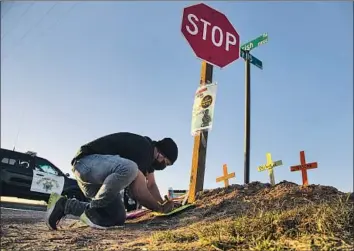  ?? Gina Ferazzi Los Angeles Times ?? HUGO CHAVEZ, an activist with the Coalition for Human Immigratio­n Rights, places crosses at the scene of a March 2 accident that killed 13 when a truck hit an SUV carrying 25 people in Holtville, Calif.
