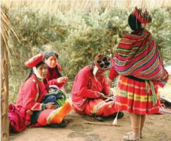  ??  ?? A group of women wearing colourful woven clothes in Patacancha, Peru. The village, home to a women’s weaving collective, is about an hour’s drive from Ollantayta­mbo, a town that offers homestays with locals.