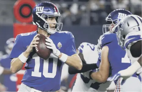  ?? PICTURE: RON JENKINS/AP ?? 0 Quarterbac­k Eli Manning prepares to throw in the New York Giants’ 20-13 defeat by Dallas Cowboys.