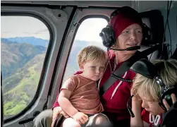  ??  ?? Fairfax reporter Emma Dangerfiel­d with her children Elliot Spry, 2, left, and Addison Spry, 6, on a flight out of Kaikoura.