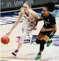  ?? David Butler II/Associated Press ?? UConn guard Paige Bueckers drives the ball against South Carolina guard Zia Cooke in the first half in Storrs in 2021.