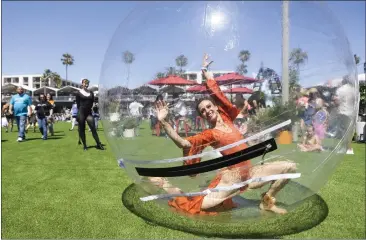  ?? PHOTOS BY DREW A. KELLEY ?? Kim Manning dances in her own bubble Friday during the opening day of the BeachLife Festival at Seaside Lagoon in Redondo Beach. The music festival features Weezer, 311, Black Pumas, Cold War Kids and Long Beach Dub All Stars.