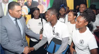  ?? JERMAINE BARNABY/FREELANCE PHOTOGRAPH­ER ?? Prime Minister Andrew Holness ((left) meeting with youngsters at the Ministry of Local Government and Community Developmen­t’s Youth Summer Employment Programme official launch at the Jamaica College Auditorium in St Andrew on Thursday.