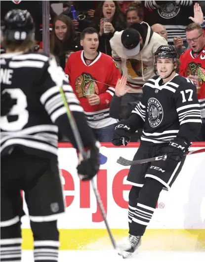  ?? JONATHAN DANIEL/GETTY IMAGES ?? Dylan Strome turns to celebrate with Patrick Kane after scoring on the Ducks in the second period Tuesday.