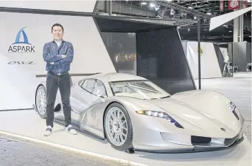  ?? BLOOMBERG ?? Masanori Yoshida, founder and CEO of Aspark, poses for a photograph beside his Aspark Owl all-electric hypercar ahead of the Paris Motor Show.