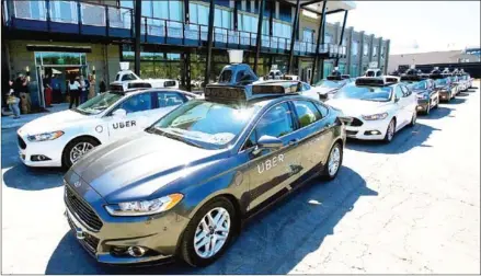  ?? AARON JOSEFCZYK/REUTERS/THE STRAITS TIMES ?? A fleet of Uber’s Ford Fusion self driving cars are shown during a demonstrat­ion of self-driving automotive technology in Pittsburgh.