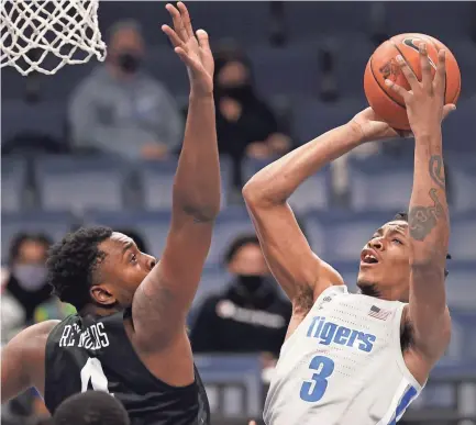  ?? JOE RONDONE/MEMPHIS COMMERCIAL APPEAL ?? Memphis guard Landers Nolley II shoots against UCF forward Jamille Reynolds during a game last season.