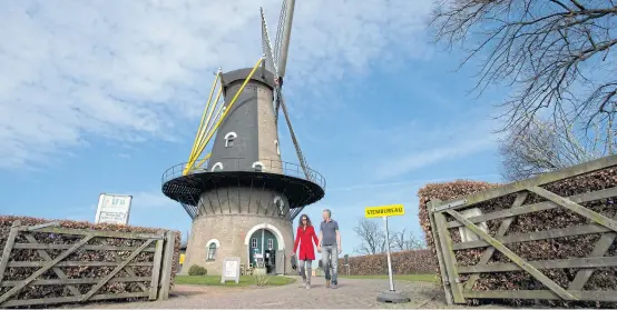  ?? AP ?? A couple of voters leave the Kerkhovens­e Molen, a windmill turned polling station in Oisterwijk, south central Netherland­s, yesterday.